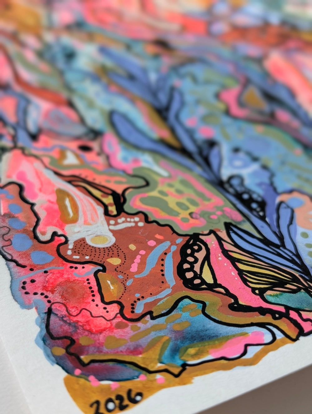 Close-up of a colorful abstract art painting featuring vibrant watercolor splashes in pink, blue, orange, green, and yellow outlined with black acrylic lines